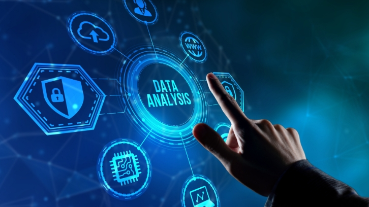 Hand interacting with futuristic data analysis interface featuring digital icons for security, cloud storage, AI chip, and analytics connected around a central data analysis hub.