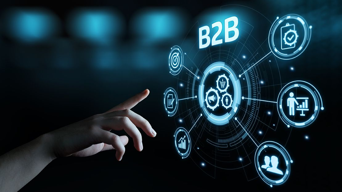 Hand interacting with a futuristic digital interface showing B2B marketing technology icons, analytics, automation tools, and data connections representing the future of B2B marketing technology. 🚀